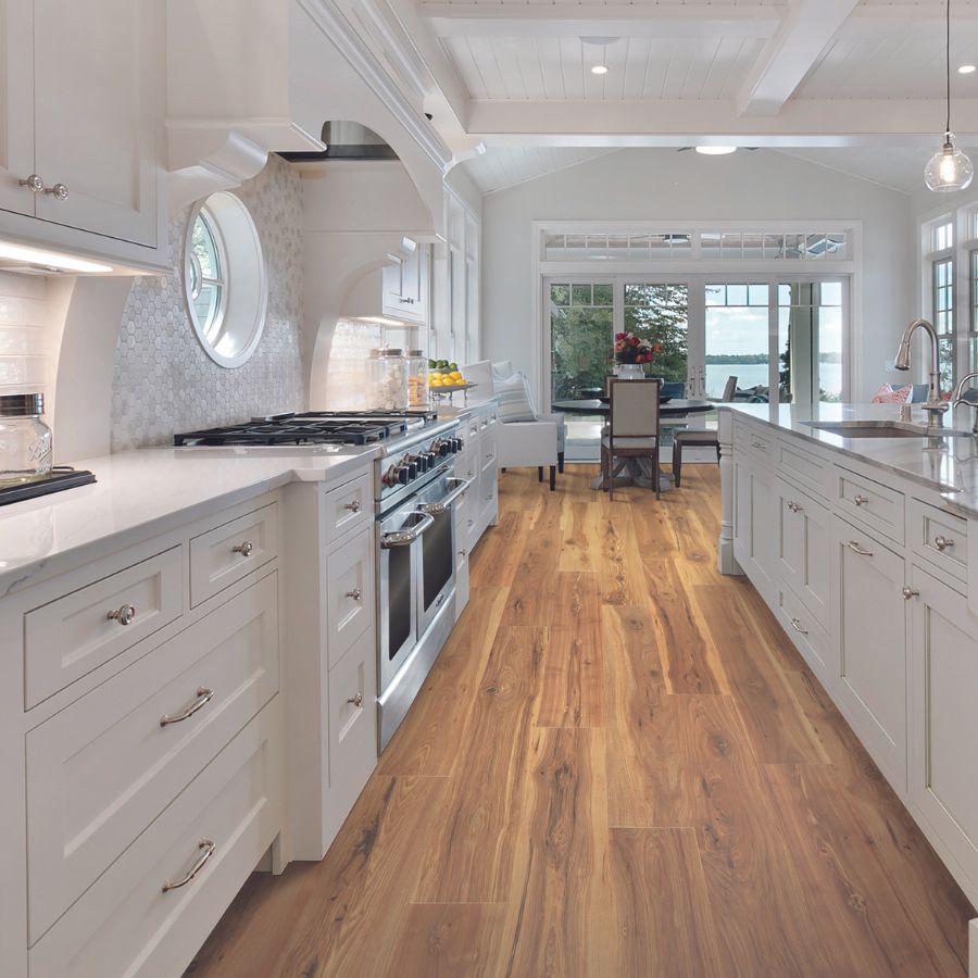 wood flooring and white stone look marble countertops in kitchen